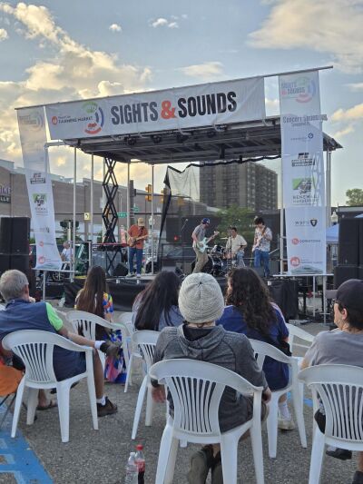  Music lovers enjoy a band playing the Sights & Sounds stage at the Royal Oak Farmers Market.  