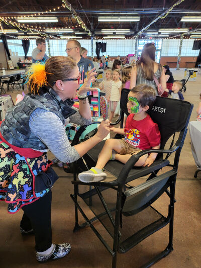  A young boy gets his face painted during a past Sights & Sounds.  