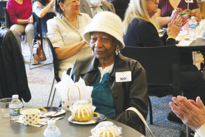  The gathered attendees at the May 8 100 Club celebration clap for Mamie Nix, 101. The Mount Clemens resident was part of the third generation of free people born in her family in Alabama and was raised in Detroit by her father.  