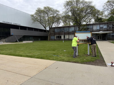  Workers install a reproduction from the Detroit Institute of Arts’ collection on Lawrence Technological University’s campus as part of the Inside|Out program. 