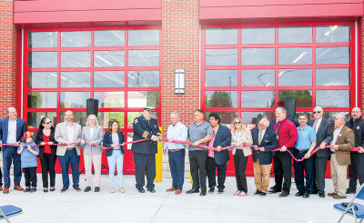  Fire Chief James Piper decoupled a hose surrounded by state and city officials and city staff on May 15.  