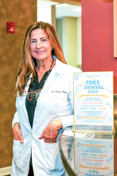  Baran poses for a photograph during the free service day at Royal Oak Smiles. 