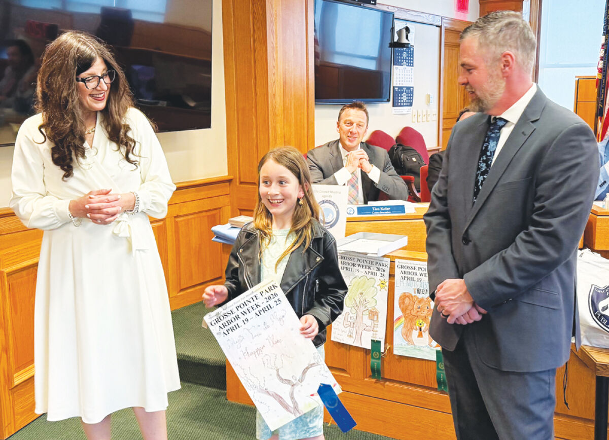  Maire Elementary fourth grader Amelia Depcinski talks about her winning Grosse Pointe Park Arbor Week  tree poster contest entry as Mayor Michele Hodges, left, and City Councilman Brent Dreaver, right, listen. 