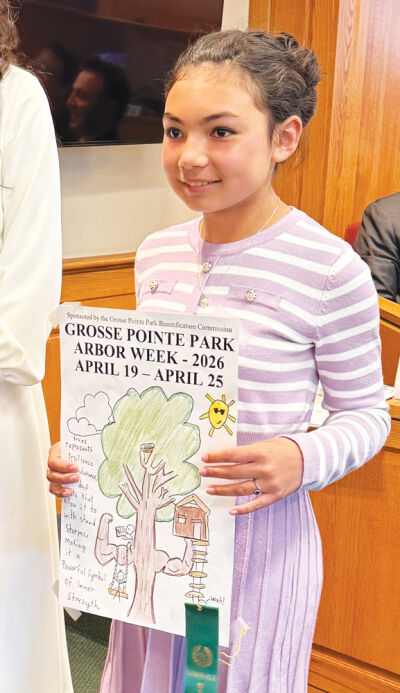   Josephine Insisiengmay holds her poster — one of two runners-up in Grosse Pointe Park’s 2026 Arbor Week poster contest. 