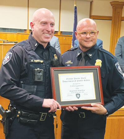  Grosse Pointe Park Public Safety Director James Bostock, right, presents  Lt. Colin Connaire, left, with his award for Supervisor of the Year during  a Grosse Pointe Park City Council meeting. 