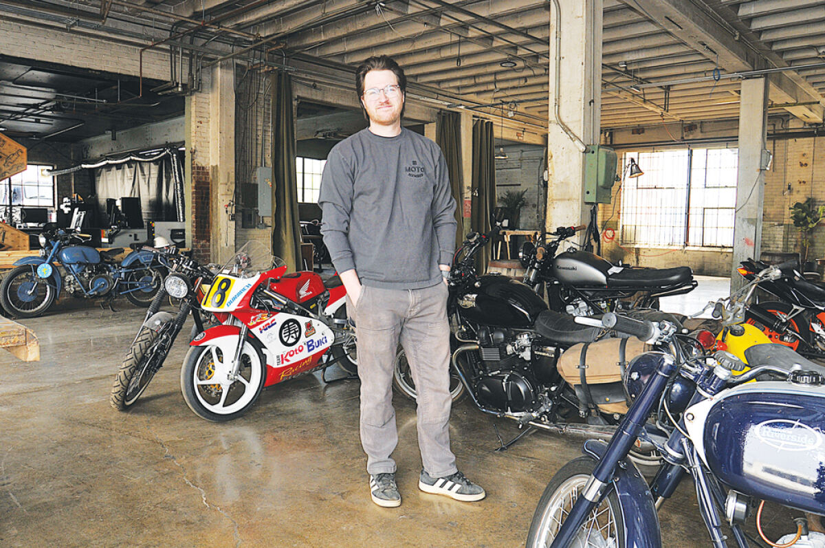  Hunter Erdman stands among several motorcycles belonging to members of Moto’s social club in Ferndale. 