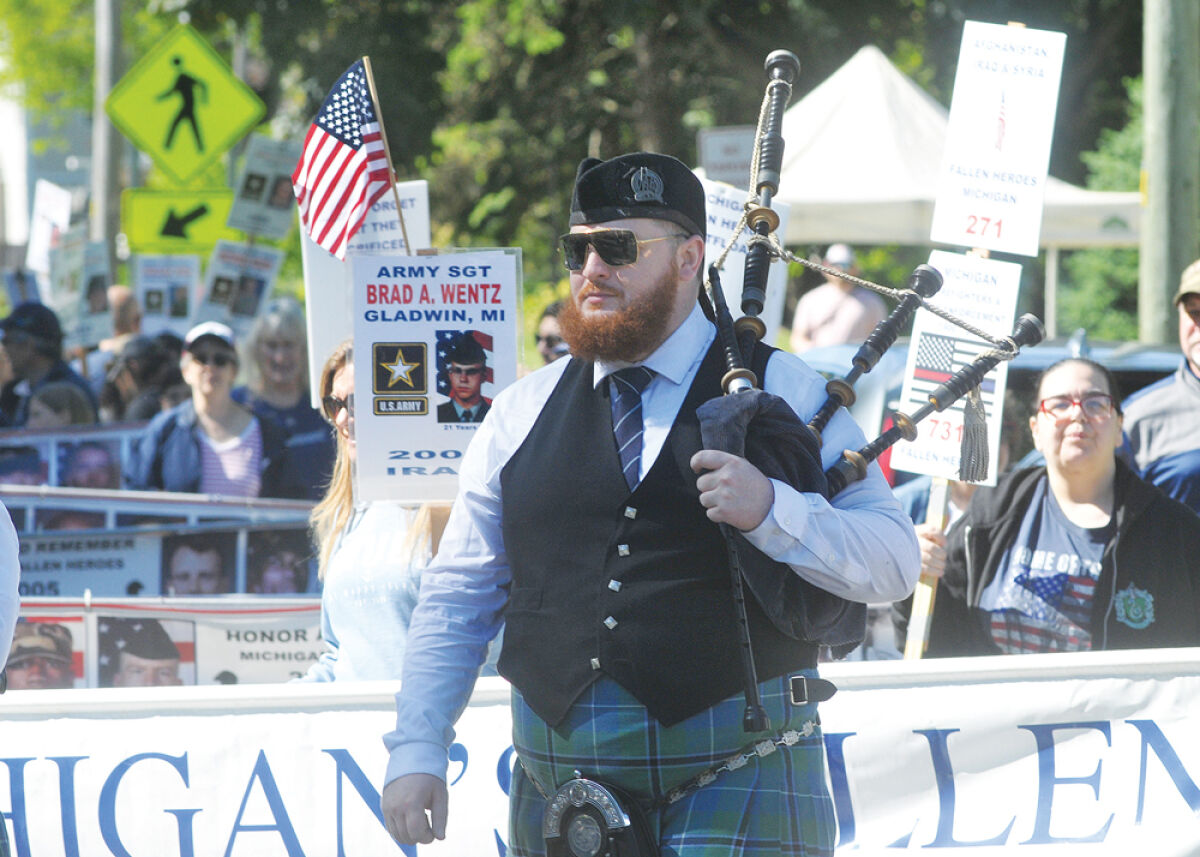  A bagpiper leads the Michigan Fallen Heroes Memorial Day float during last year’s parade. 