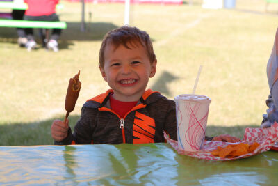 A child enjoys some snacks during the 2024 Shelby Township Down Home Days Festival.