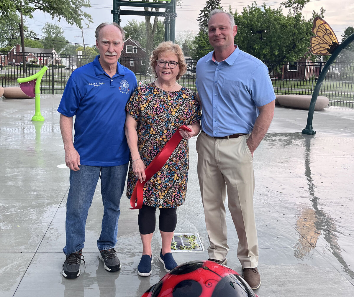  Roseville Mayor Robert Taylor, left; Michelle Rollinger Kauffold, center; and Roseville City Manager Ryan Monroe pose for photos just after the ribbon cutting for the new splash pad May 19. 