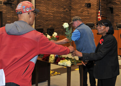 Southfield Veterans’ Commission Chair Barbara Seldon hands roses to veterans during the Memorial Day ceremony at the Southfield Municipal Campus. 