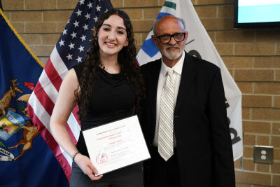  Shila Lepuri of Utica received a $2,000 scholarship from General Dynamics Land Systems. She is pictured here with Karl Oskoian, executive director of the Sterling Heights Area Community Foundation. 