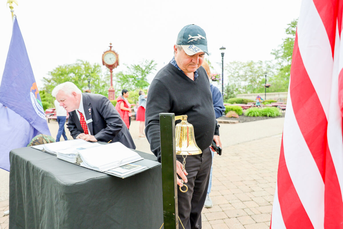  The Heroes of Michigan Travelling Memorial honors soldiers from Michigan who have served with various military branches. Attendees of Utica’s annual Memorial Day ceremony were asked to ring a bell if they knew someone who died in combat. Stephen Sierawski, chief judge, 41-A District Court, rings the bell for Jason Freiwald, whose family he knew well.  