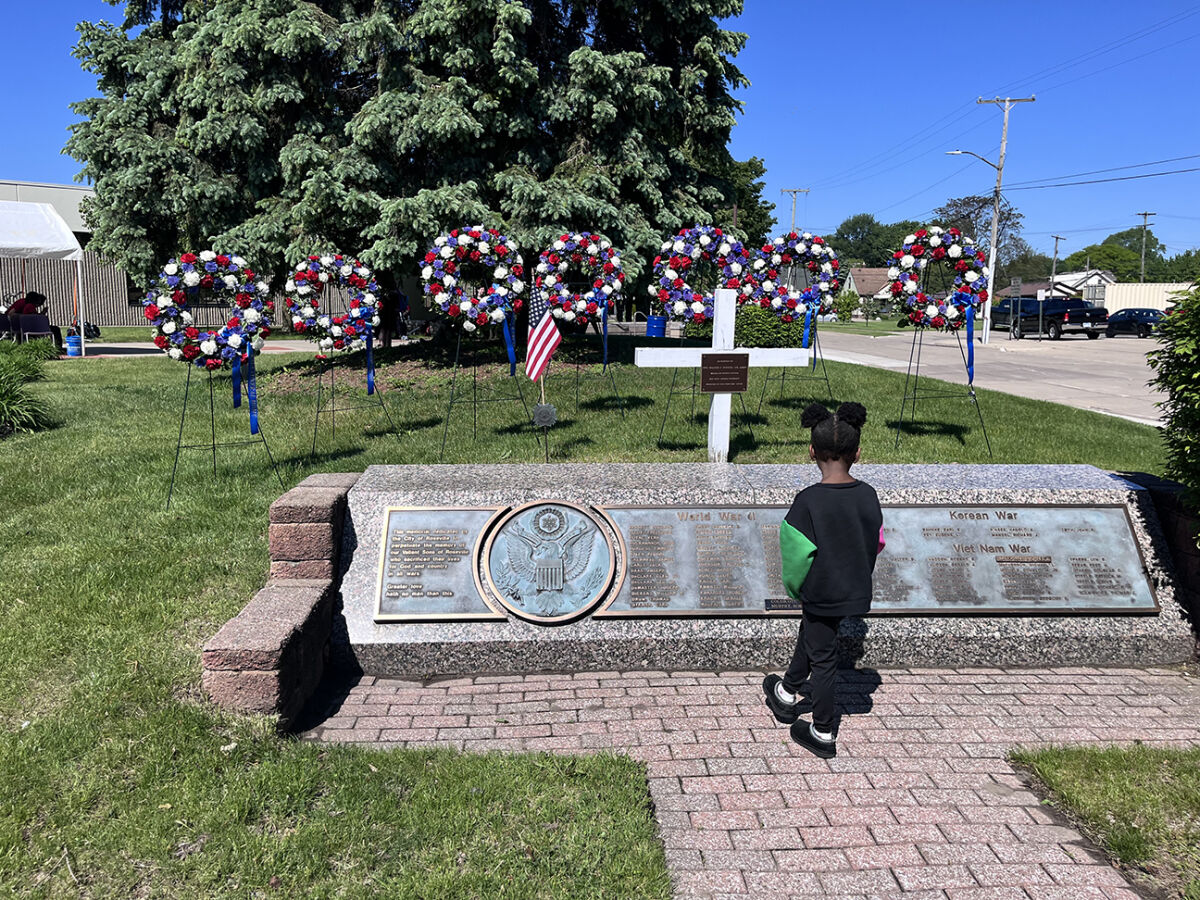  Five-year-old Kelise Hill, of Roseville, views the names of Roseville military veterans who died in wars and are memorialized at the Roseville City Center Complex. 