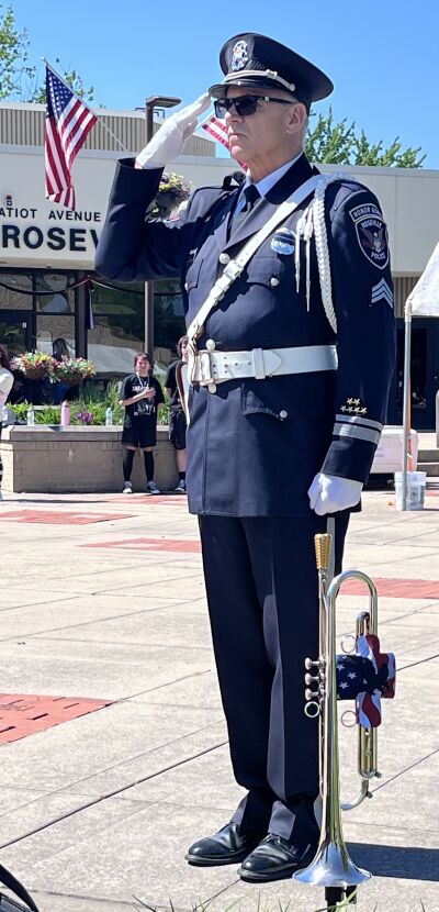  Retired Roseville Police Sgt. Keith Waller played taps to remember those who died while serving. 