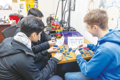  Students in the 3D Printing Club at Lawrence Technological University assemble parts created with a 3D printer. Members will be leading several workshops at the Hazel Park District Library this summer. 