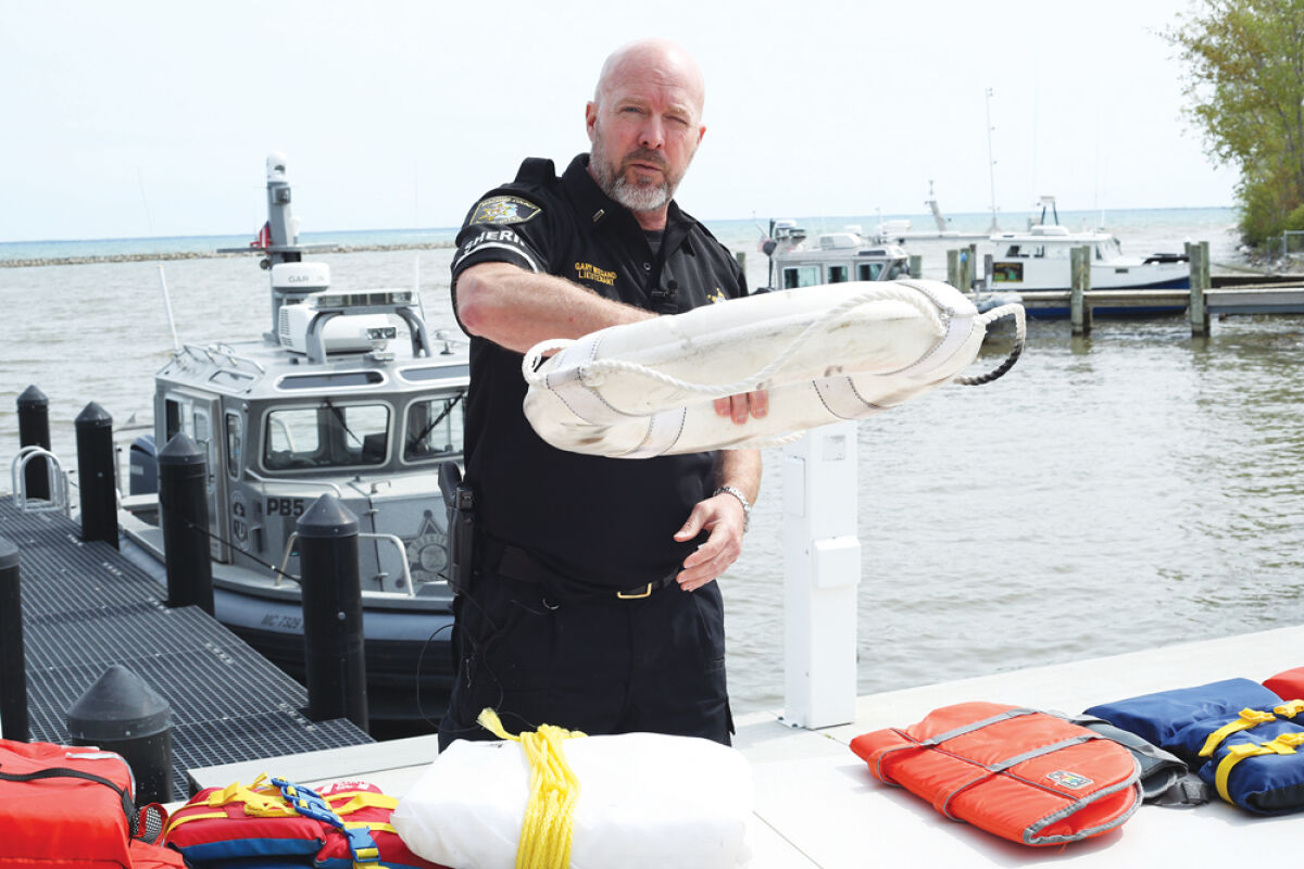  Lt. Gary Weigand of the Macomb County Sheriff’s Office Marine Division showcases a Type IV throwable flotation device. These are to be used along with life jackets to prevent drowning. 