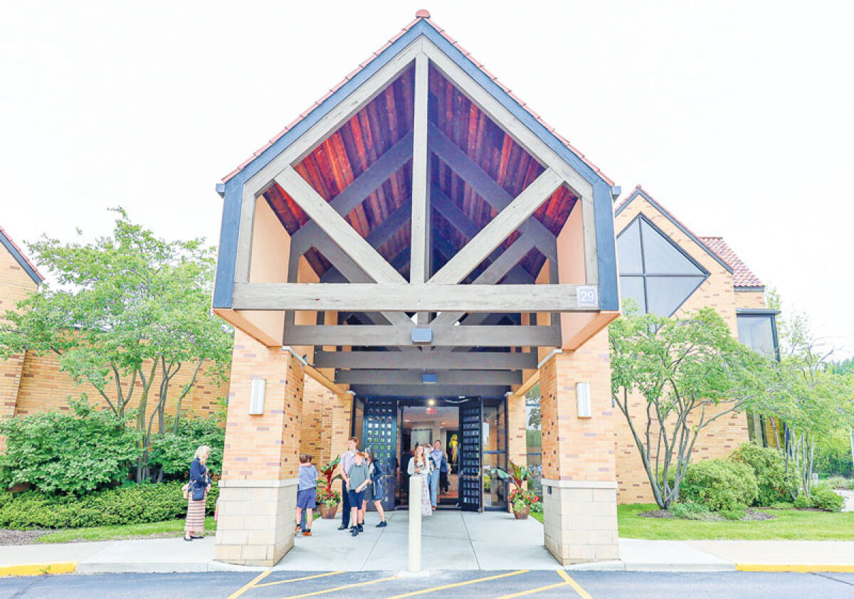  Parishioners at Our Lady of Refuge, in Orchard Lake, are seen leaving after a recent Sunday Mass. “Parishioners love their priests and their parishes,” said Father Mario Amore, chair of the restructuring efforts. 