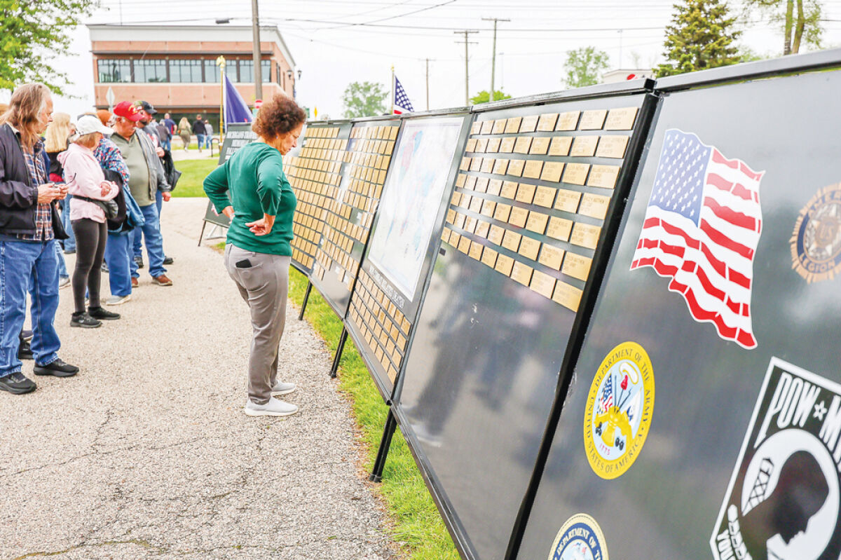   Attendees of the city of Utica’s annual Memorial Day ceremony view Michigan’s Traveling Memorial of Fallen Military, which included the names of all Michigan soldiers, sailors, Marines and airmen who lost their lives defending the country since 1990. 