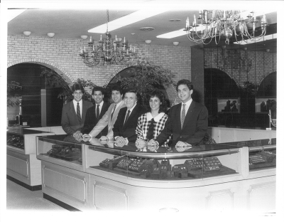  In this photo from the 1980s, Ahee Jewelers patriarch Edmund T. “Ed” Ahee, third from right, poses in the store with five of his seven children, from left, Greg, Chris, Peter, Pamela Ahee Thomas and John. 