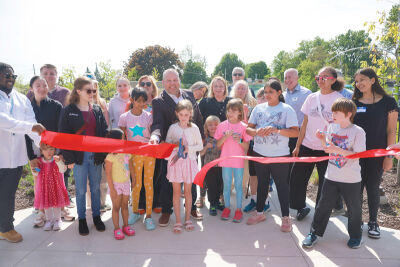  City officials — joined by community members, Brooklands neighborhood residents, Art on Auburn 2 artists and others — cut the ribbon to open Brooklands Plaza May 21. 