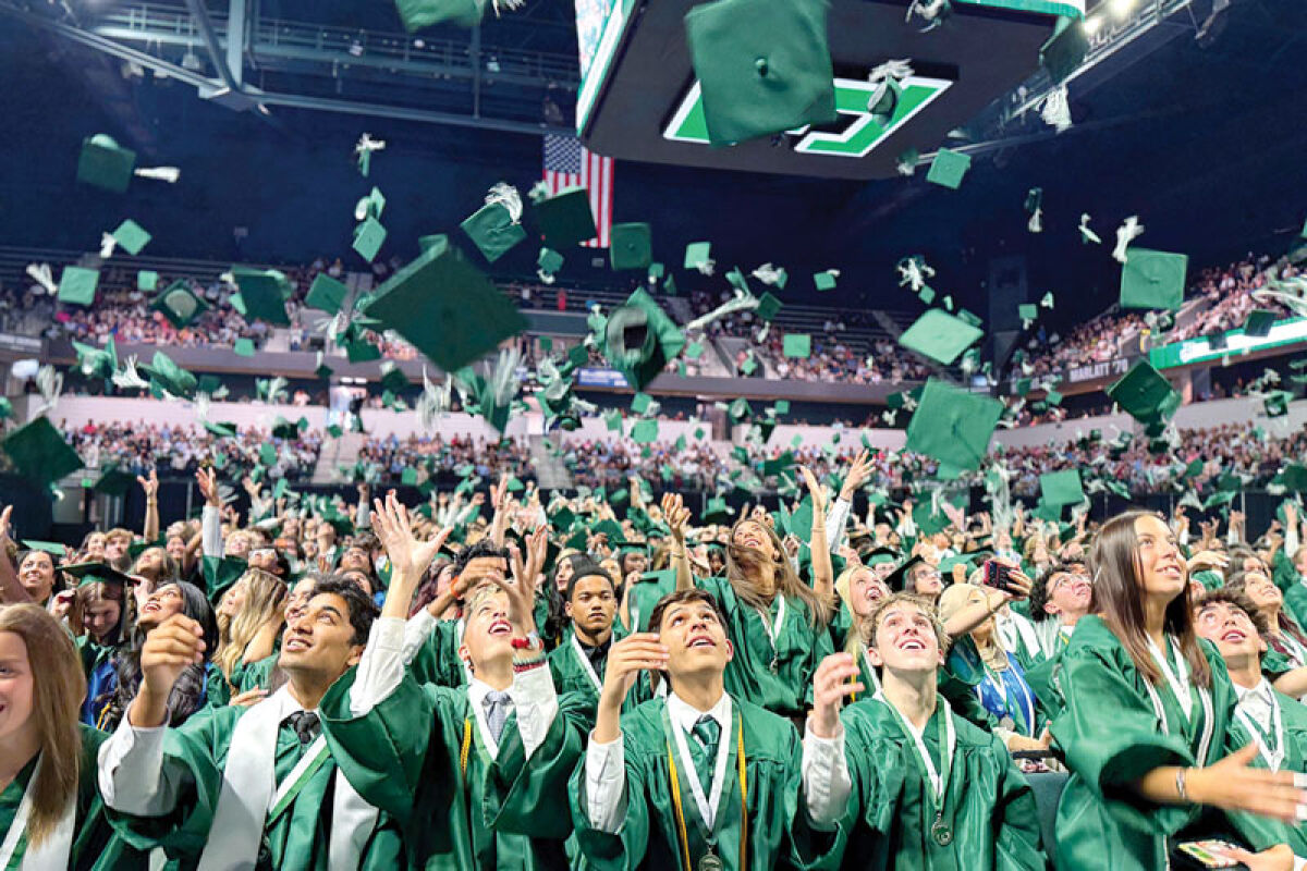  The members of Novi High School’s Class of 2026 throw their mortarboards in the air to celebrate their graduation at the George Gervin GameAbove Center May 17. 