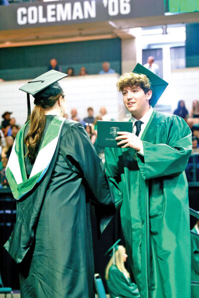  Benjamin Corbett receives his diploma. 