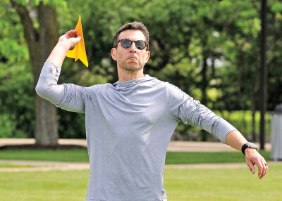  Danny Seidman prepares to launch his paper airplane. 