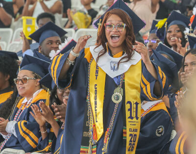  DTE gave two $1,000 scholarships to University High School Academy graduates, which were announced during the June 5 commencement ceremony. Zahara Cartwright steps up to the stage in joyous surprise as her name is called for the first scholarship. 