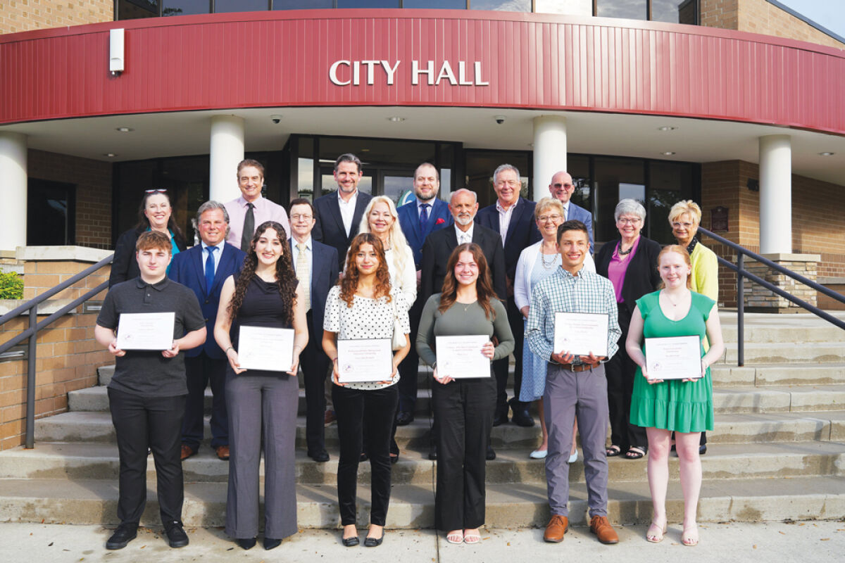  Sterling Heights Area Community Foundation scholarship winners stand with foundation board representatives and Sterling Heights City Council members following a May 19 award ceremony. 