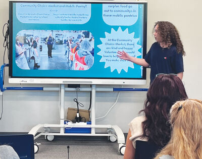  Wolfe Middle School sixth grader Kaydan Miller takes attendees on a journey through his digital media campaign. 