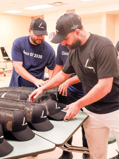  Staff members from Legends Salon/Barbershop distributed Legends Salon/Barbershop baseball caps to the Grissom Middle School students before they left for C.J. Barrymore’s.  