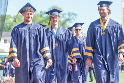  Fraser High School graduates, from left, Anthony Serio, Jefferey Delikta, Ethan Gerber and Tyler Summerville talk a walk around UWM Field at the June 6 commencement ceremony. 