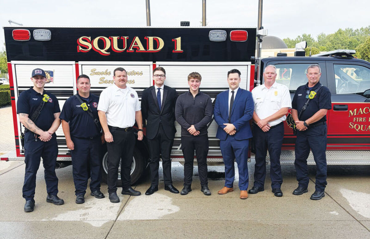  Macomb Township’s newest full-time firefighters — Christian Popp, middle left, Justin Edwards and Anthony Heppler — pose for a photo with Macomb Township Fire Department leadership. 