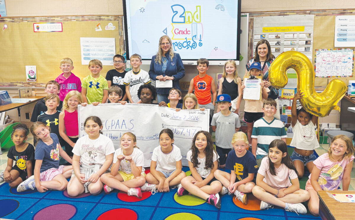  On behalf of all the second graders in the Grosse Pointe Public School System, Theresa Comilla’s second grade class at Ferry Elementary in Grosse Pointe Woods presents Grosse Pointe Animal Adoption Society Executive Director Corinne Martin with a check June 2 for more than $1,000 raised by students for the nonprofit. 