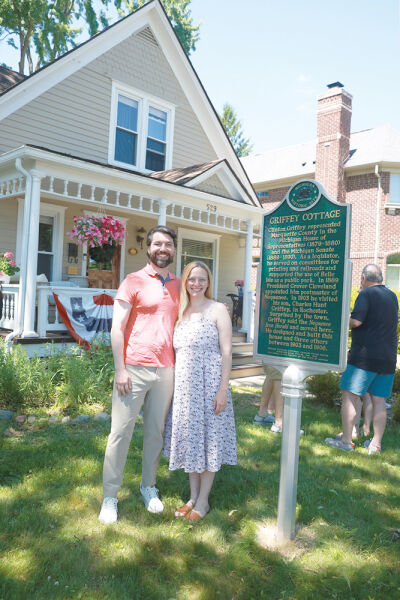  Homeowners Hayden McNeil and Julia Johnson  stand in front of the Michigan Historical Marker that  was dedicated at their historical home, Griffey Cottage, June 7. 