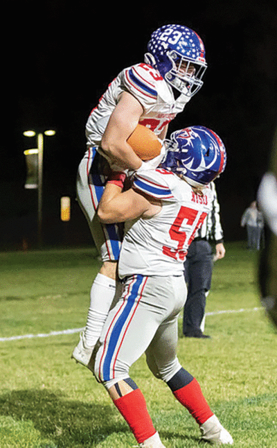  Sterling Heights Parkway Christian junior running back Kyler Maiorana celebrates a touchdown run with junior  lineman Mark Nesler Jr. 