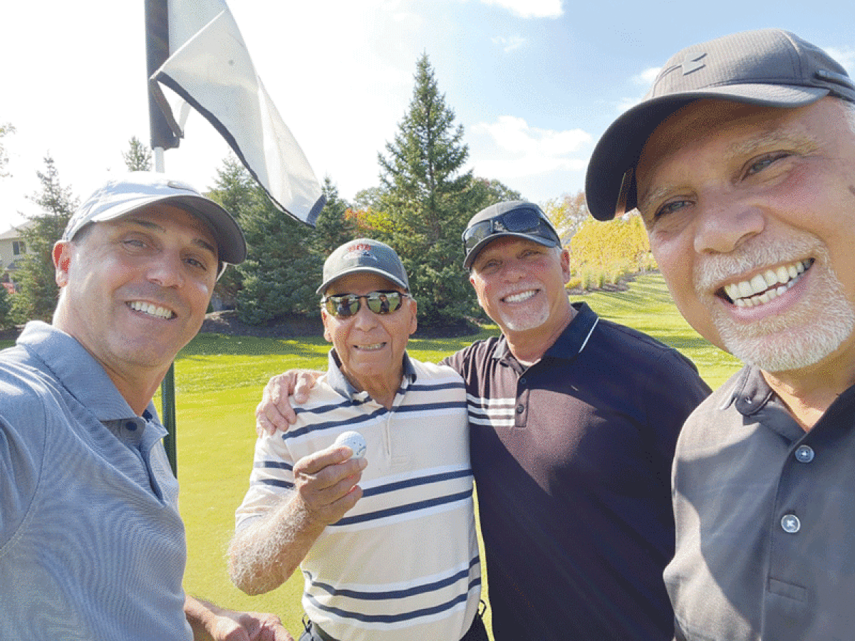   Shelby Township native Pete Backus, 95, second from left, tallied his first-ever hole-in-one at the Glacier Club in  Washington Township Oct. 11. Helping Backus celebrate  is his son, Peter Backus, left, and nephews Paul Thomas,  second from right, and Michael Thomas. 