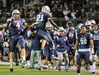  Dakota senior safety Jacob Leija celebrates on the sidelines after making a play. 