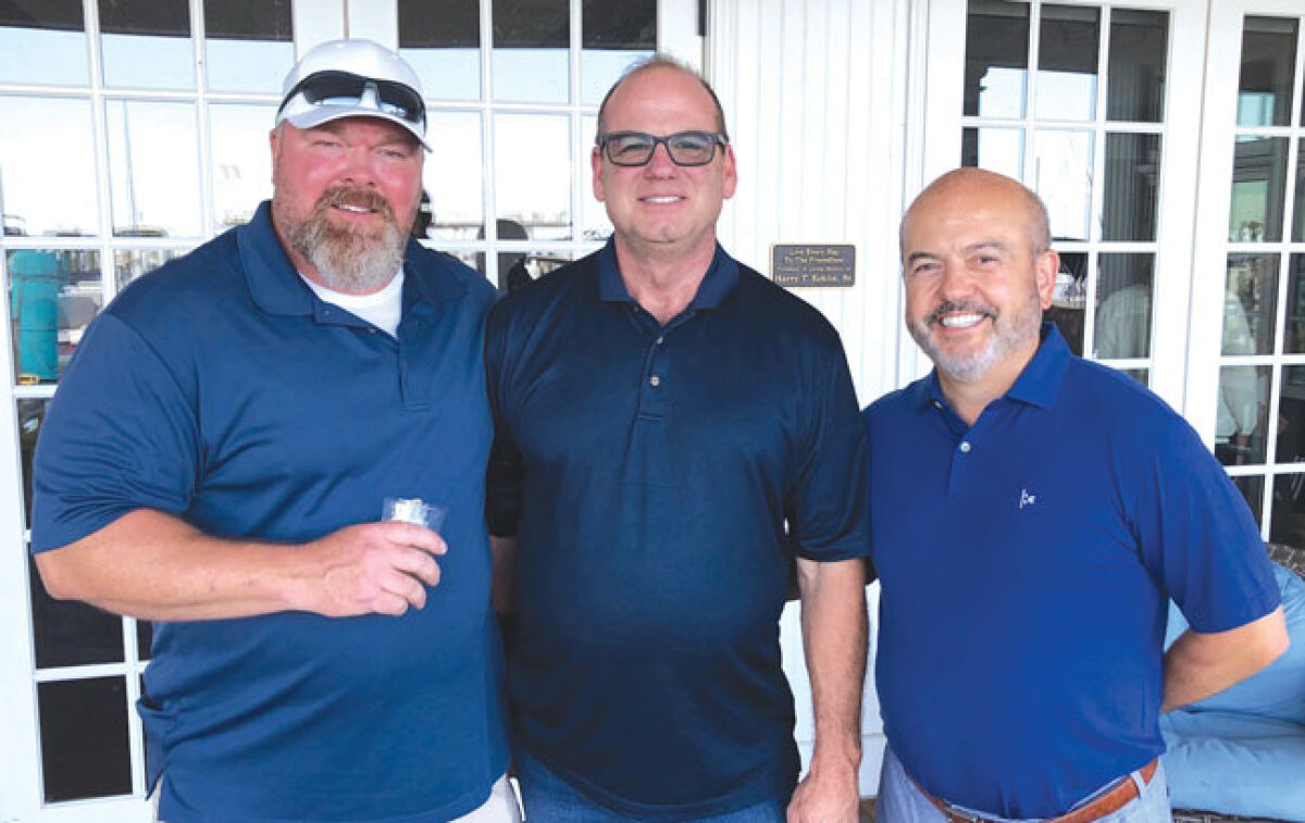  From left, Grosse Pointe Farms Public Safety Detective Bryan Ford, Lt. Thomas Shimko and Farms Mayor Louis Theros take part in a retirement celebration for Ford and Shimko July 14 at Pier Park in the Farms. 