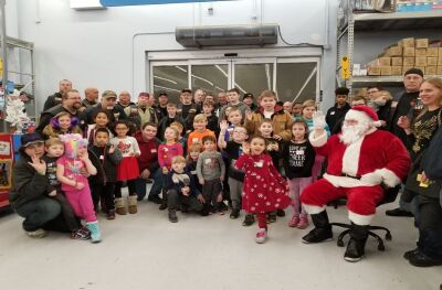 Shop with a Warthog brings together active and retired police officers, court and jail officers, and firefighters who accompany children on a Christmas shopping trip at Walmart. 