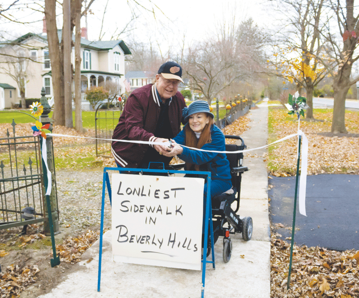  Paul and Anne Kleppert celebrate the new sidewalks installed by their house.  