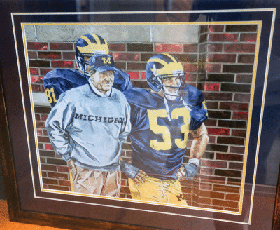 : A print of Jeff Joseph’s painting, “Coach Lloyd Carr,”  depicts the former University of Michigan coach. 