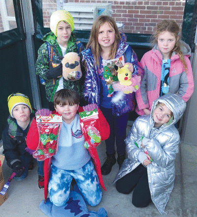  Makenna Markley, 8, of Grosse Pointe Park, center, is pictured outside Defer Elementary School with friends who joined her in donating items for homeless pets. 
