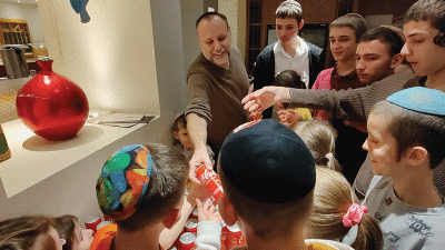  Ethan Gross distributes Cokes to the excited children of the Mishpacha Orphanage of Odesa.  