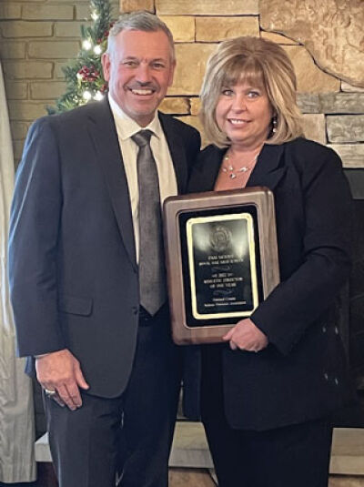  Royal Oak’s Pamela Moore and Brian Gordon celebrate Moore being named Oakland County Athletic Director of the year Dec. 15 at Oakland County’s Holiday Party and Awards Ceremony. 