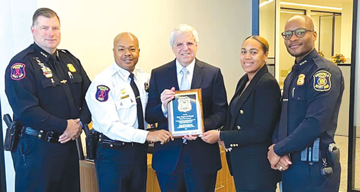  Officers and the Friends of Southfield Police present Gary Torgow with a plaque in appreciation of the college scholarships he provided to children of officers and dispatchers. 