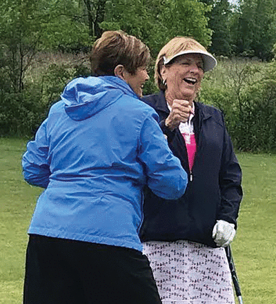  Retired Warren Woods Tower Athletic Department secretary Grace Oberski, left, and retired Warren Woods Tower Athletic Director Jan Sander cheer after Sander makes a birdie June 20 at Timberwood Golf Course.  