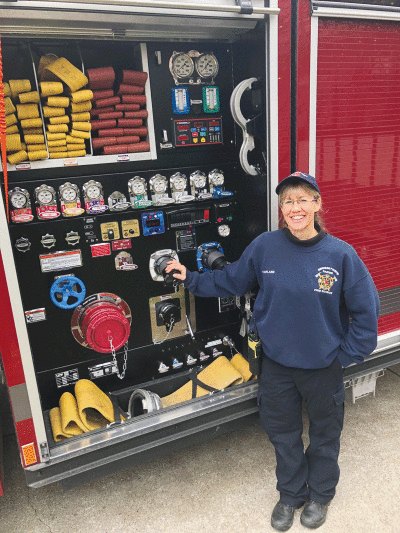  Grosse Pointe Farms Public Safety Department Fire Specialist Sundee Harland stands next to the department’s newest firetruck, which she helped design. 