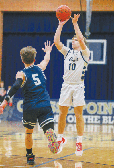  South senior Noah Stiyer launches a shot from three-point land against Dakota. 