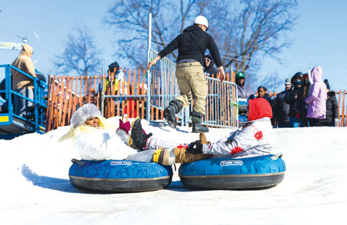  Attendees at last year’s Winter Blast in Royal Oak have fun on the large snow slide. The slide at this year’s event will be 25 feet in height and 200 feet long. 